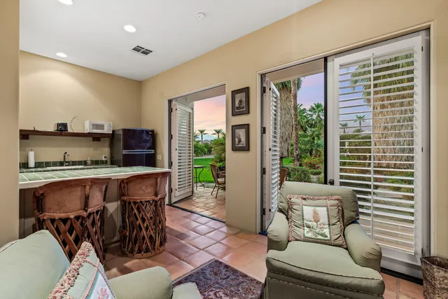 a living room with furniture and a floor to ceiling window