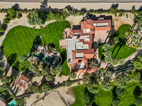 an aerial view of a house with a yard and lake view
