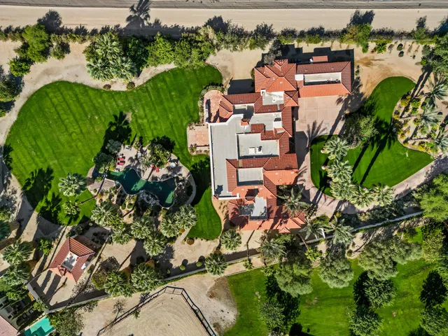 an aerial view of a house with a yard and lake view