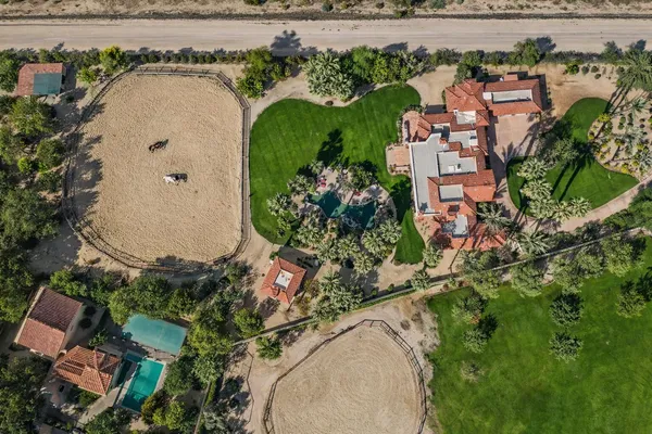 an aerial view of a house with a yard and lake view