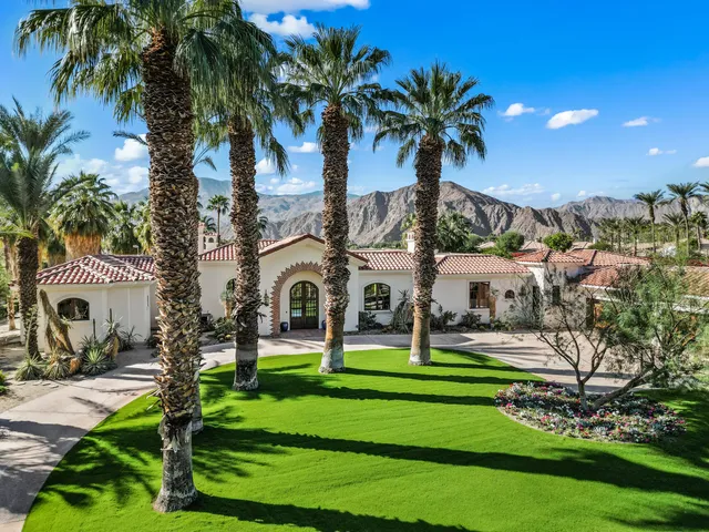 a front view of multiple houses with yard