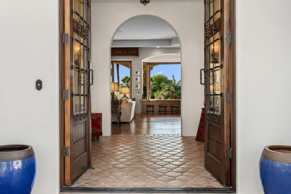 a living room with furniture and a floor to ceiling window