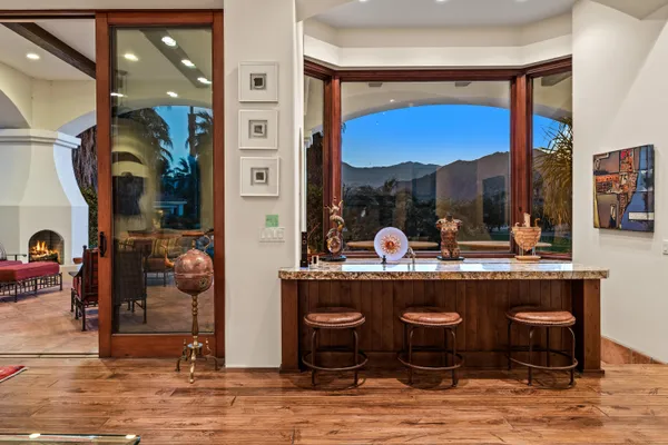 a living room with fireplace furniture and a floor to ceiling window
