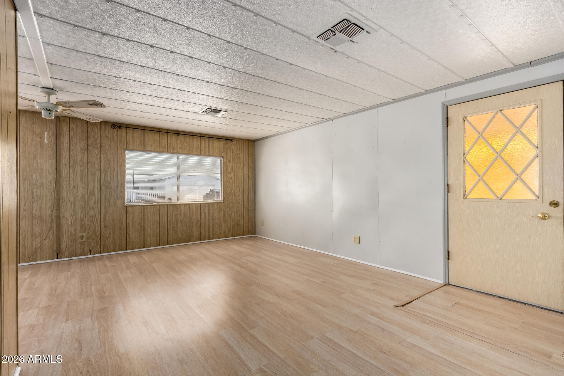 8421 East Main Street, Unit 140 Mesa, AZ 85207 - Photo 23 of 28 an empty room with wooden floor and windows