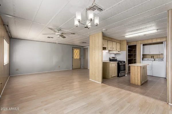 a view of a kitchen with refrigerator and windows