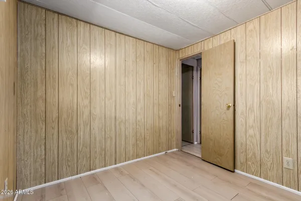 a view of an empty room with wooden walls