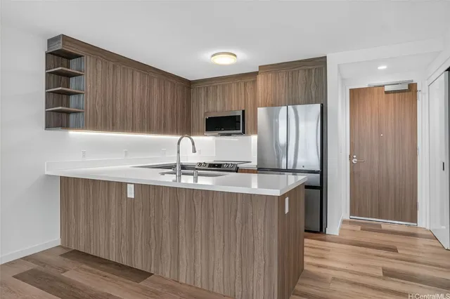 a kitchen with stainless steel appliances granite countertop a sink stove and refrigerator