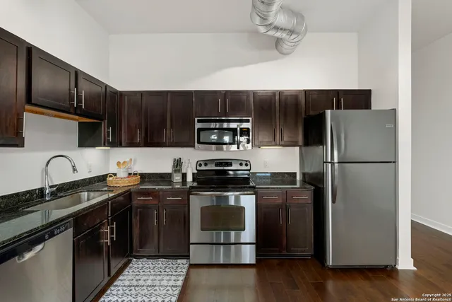 a view of a hallway with a livingroom and a bathroom