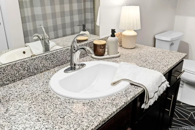 a view of a city from a balcony with furniture