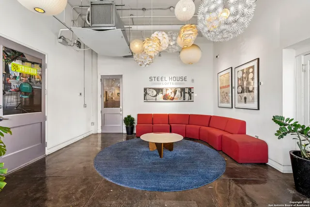 a living room with lots of furniture and a painting on the wall