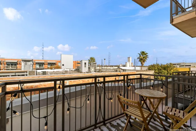 a living room with furniture kitchen view and a chandelier