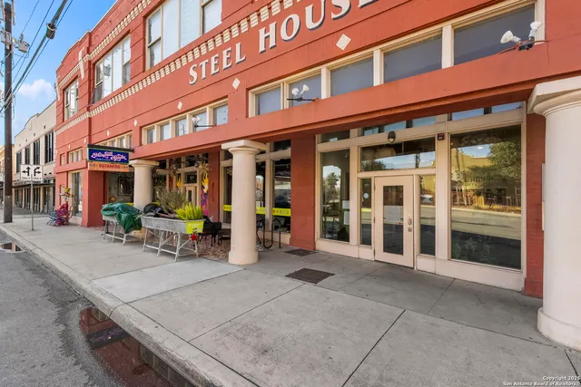 an aerial view of a building with an outdoor space
