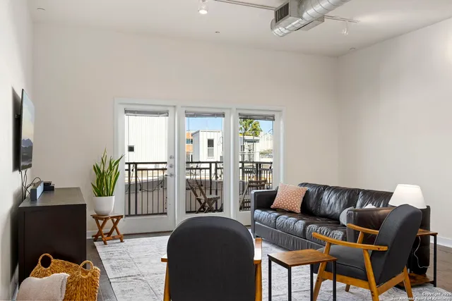 a living room with furniture fireplace and flat screen tv