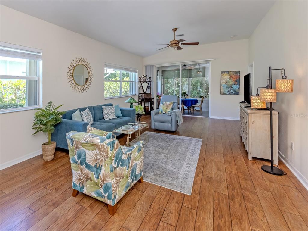 205 Reclinata Circle Venice, FL 34292 - Photo 8 of 62 a living room with furniture and a wooden floor