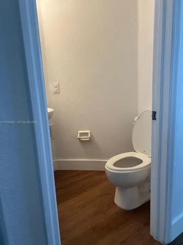 a closeup of a sink and a stove with wooden floor
