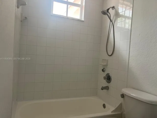 a bathroom with a shower and a toilet