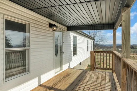 an empty room with wooden floor and a window