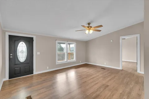 wooden floor in an empty room with a window