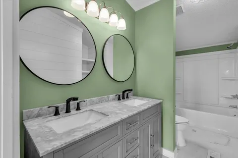 a kitchen with a sink cabinets and wooden floor