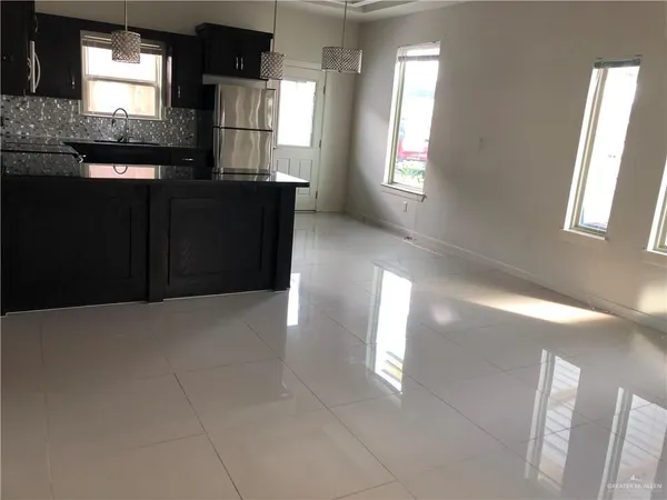 a kitchen with refrigerator and window