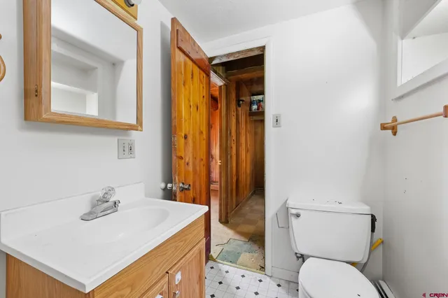 a bathroom with a sink a toilet and mirror