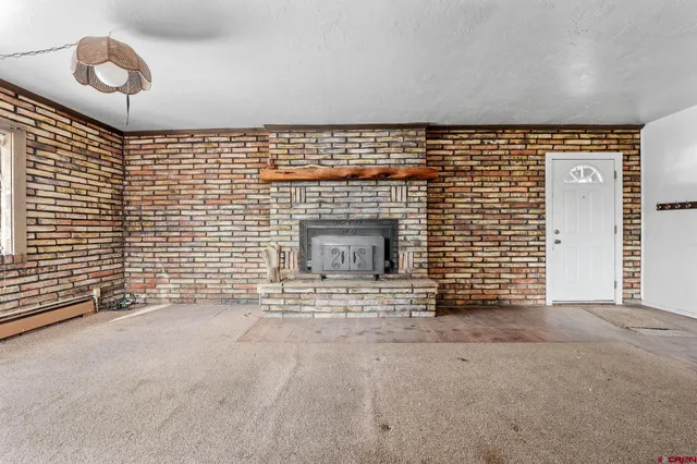 a view of an empty room and a fireplace