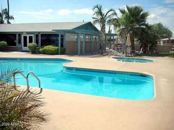 a patio with a table and chairs under an umbrella