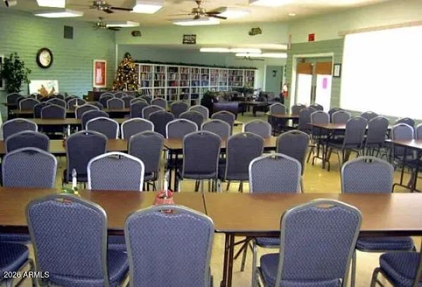a living room with furniture a pool table and a large window