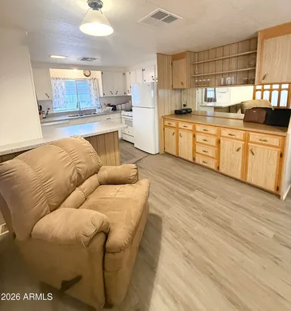 a large kitchen with a stove a sink dishwasher and a refrigerator