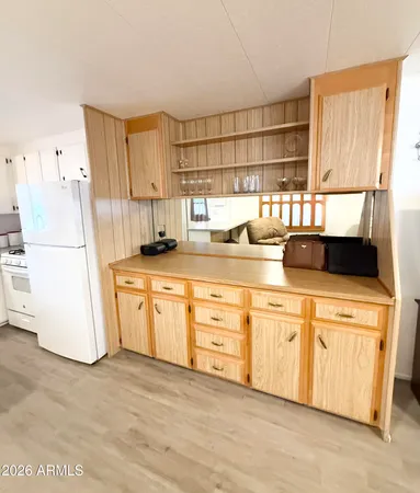 a kitchen with a refrigerator and a sink