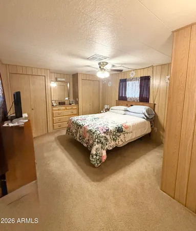 a bedroom with a bed and mirror