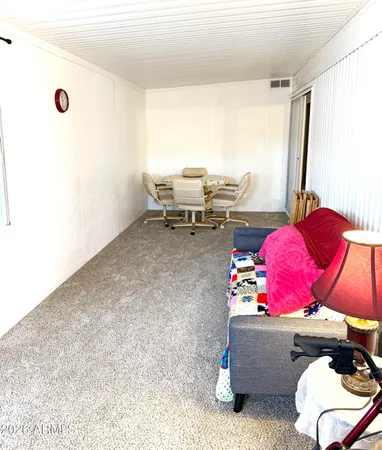 a living room with furniture and a floor to ceiling window