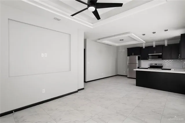 a view of a kitchen with furniture and a ceiling fan