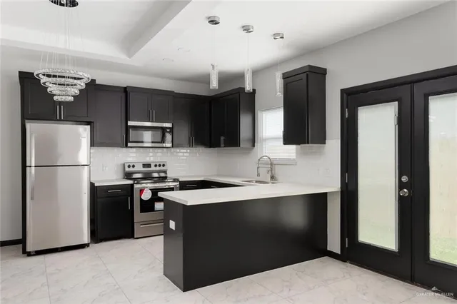 a kitchen with a refrigerator stove and sink