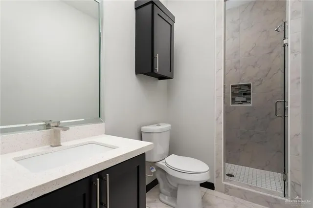 a view of a backyard with plants and brick wall