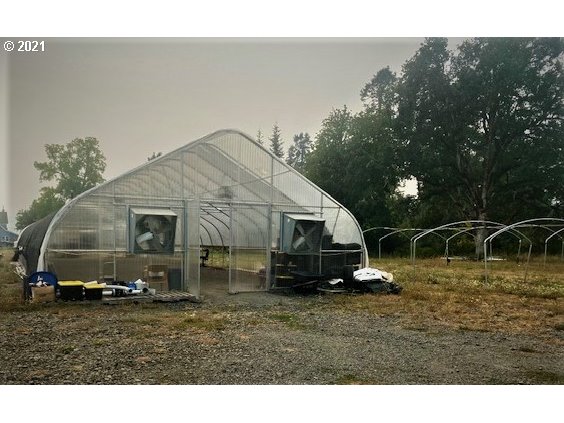 1021 Upper Camas Road Camas Valley, OR 97416 - Photo 20 of 27 a view of a barn in the middle of a yard