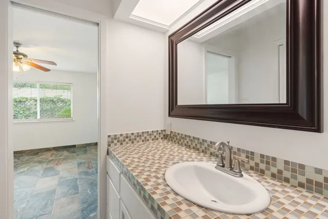 a bathroom with a sink and a mirror