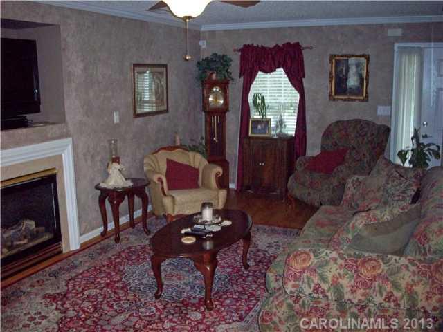 8027 Trotter Road Charlotte, NC 28216 - Photo 2 of 11 a living room with furniture and a fireplace