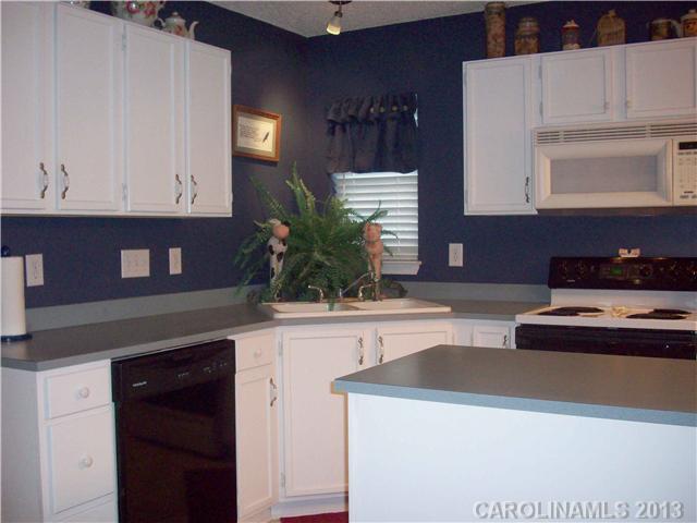 8027 Trotter Road Charlotte, NC 28216 - Photo 4 of 11 a kitchen with a refrigerator and cabinets