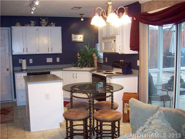 8027 Trotter Road Charlotte, NC 28216 - Photo 5 of 11 a dining room with furniture and a large window