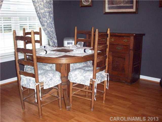 8027 Trotter Road Charlotte, NC 28216 - Photo 6 of 11 a dining room with furniture and wooden floor