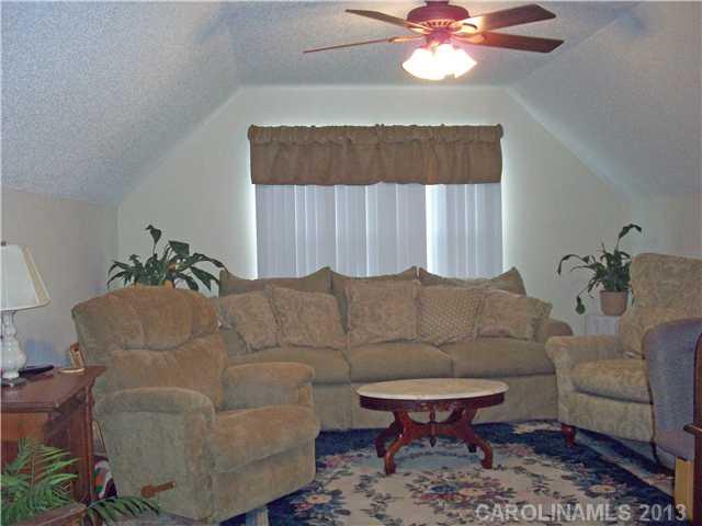 8027 Trotter Road Charlotte, NC 28216 - Photo 7 of 11 a living room with furniture and a chandelier