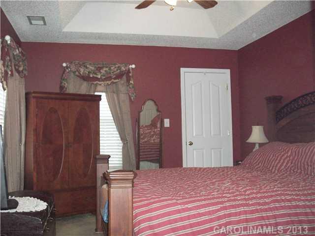 8027 Trotter Road Charlotte, NC 28216 - Photo 8 of 11 a bedroom with a bed and a dresser