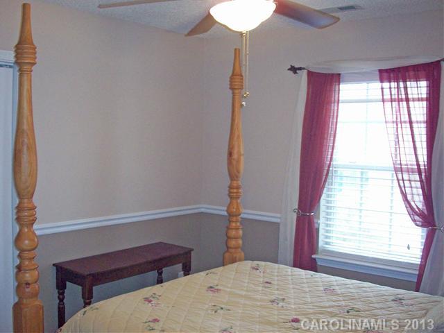 8027 Trotter Road Charlotte, NC 28216 - Photo 9 of 11 a bedroom with a bed and a window