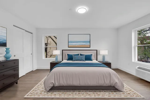 a bedroom with a large bed and a window