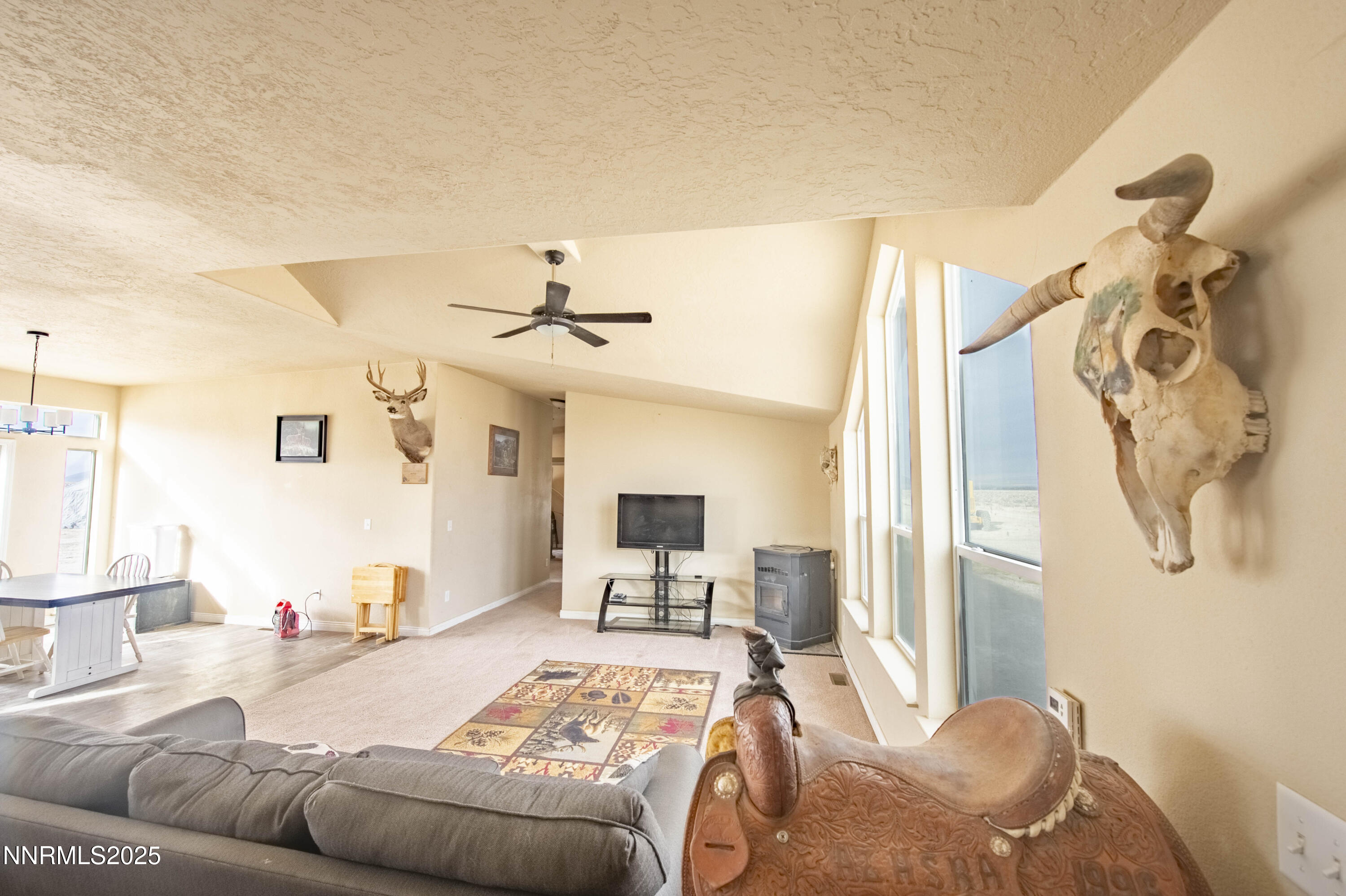 a bedroom with furniture and a flat screen tv
