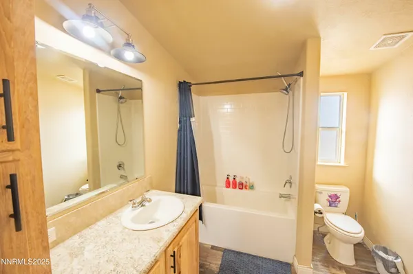 a bathroom with a sink mirror and a bathtub