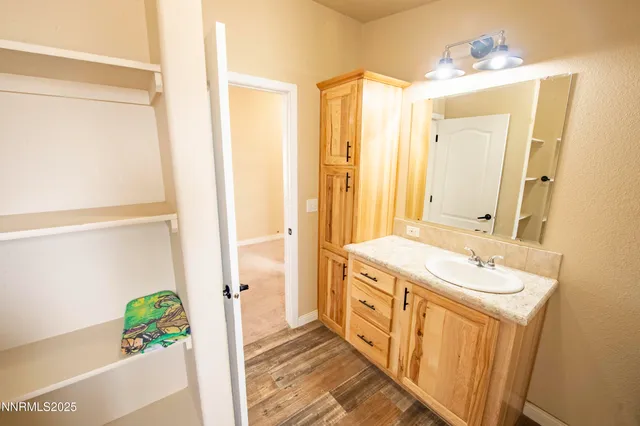 a view of a bedroom with wooden floor and furniture