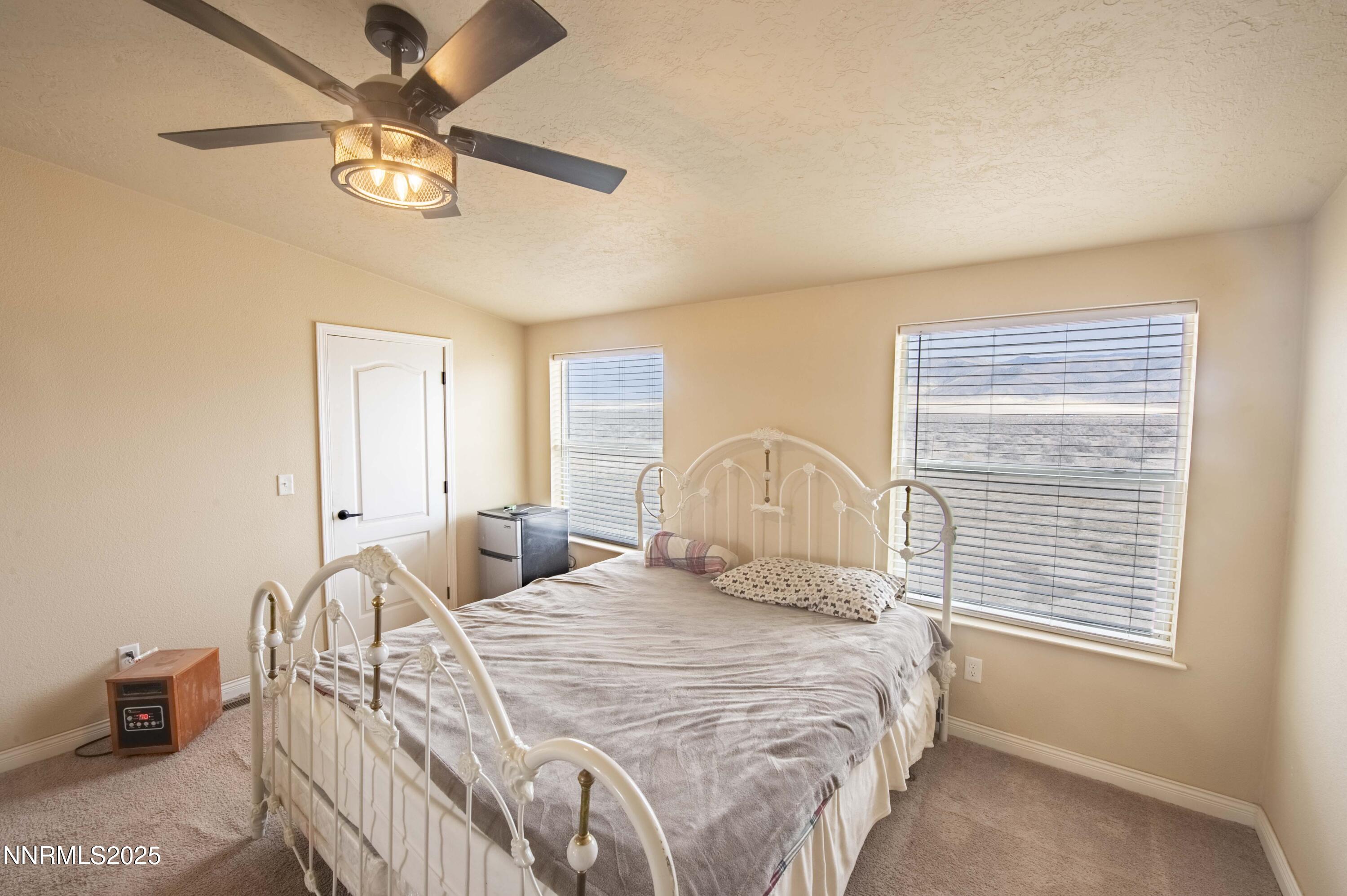 3139 Muddy Road Winnemucca, NV 89445 - Photo 27 of 46 a bedroom with a bed and a chandelier