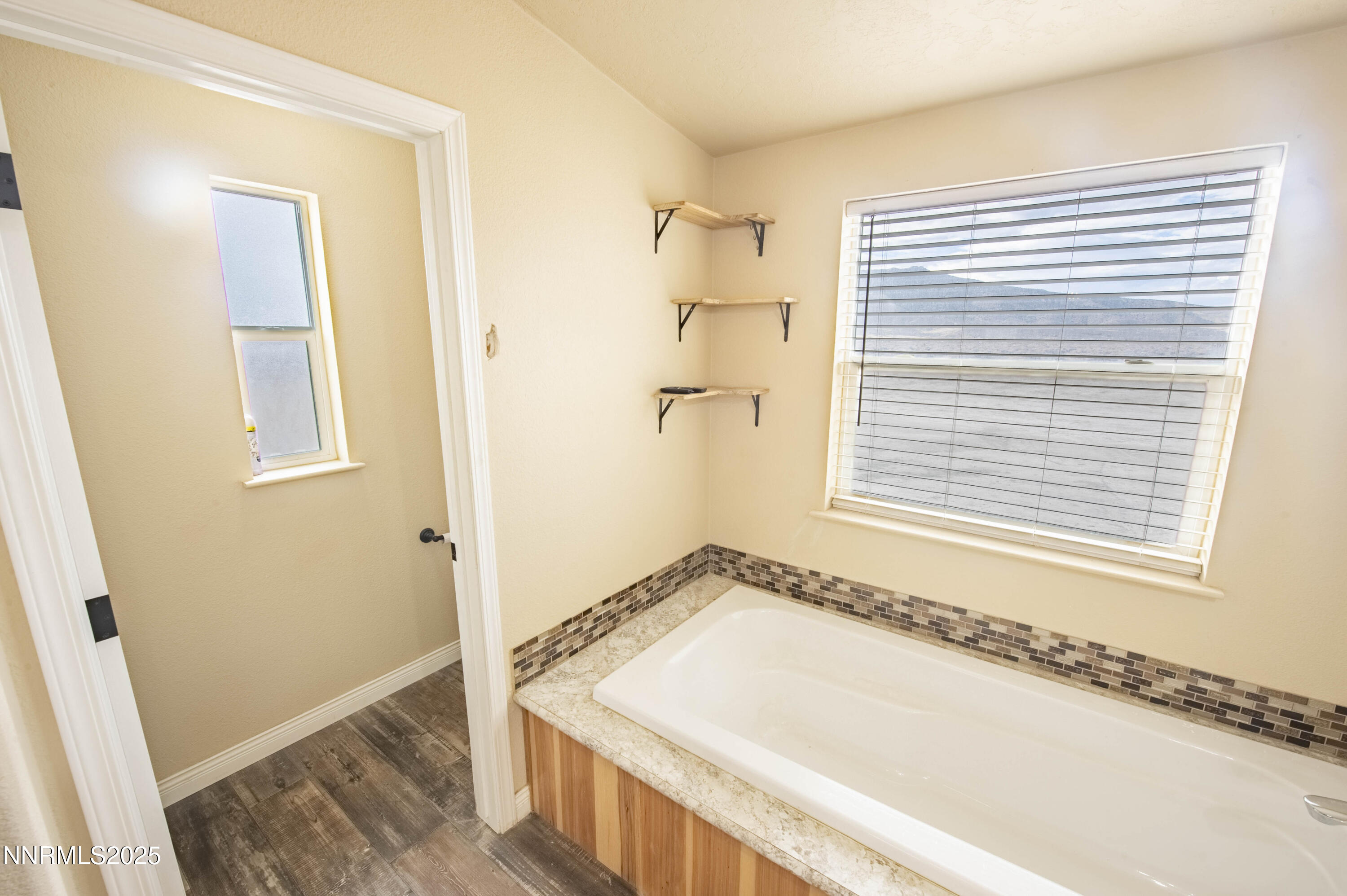 3139 Muddy Road Winnemucca, NV 89445 - Photo 32 of 46 a bathroom with a tub a sink and a window